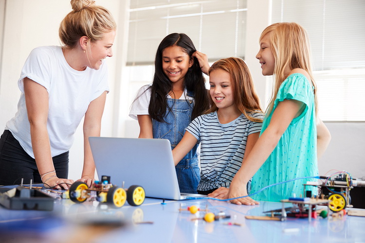 children in an after-school program with woman volunteer