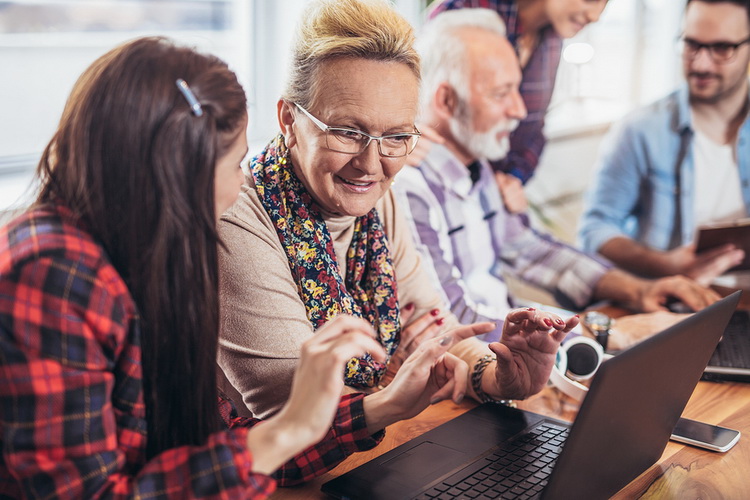 youthful volunteers teach computer skills to older people