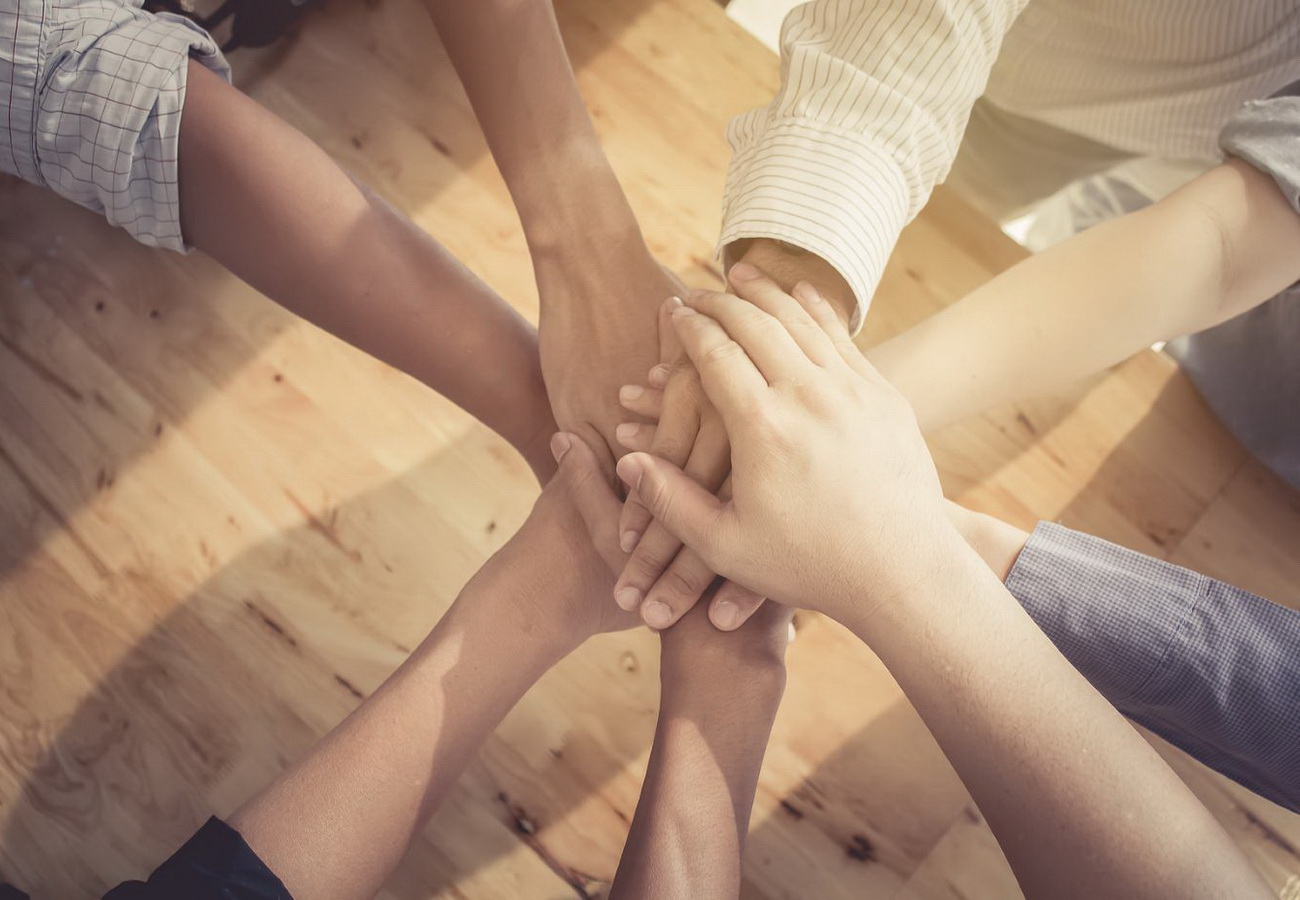 view of 7 hands overlapping in unity